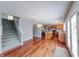 Open-concept living room and kitchen with hardwood floors and staircase to the second floor at 5989 Ashmore Ln, Carmel, IN 46033