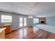 Living room features hardwood floors, fireplace, and access to the kitchen and backyard at 5989 Ashmore Ln, Carmel, IN 46033
