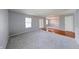 Living room featuring plush gray carpeting, soft gray walls, hardwood flooring, and natural light at 5989 Ashmore Ln, Carmel, IN 46033