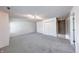 Spacious living room area with neutral carpeting and ample closet storage space at 5989 Ashmore Ln, Carmel, IN 46033