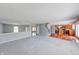 Spacious open-concept living room with gray walls, hardwood floors, and plush carpeting throughout at 5989 Ashmore Ln, Carmel, IN 46033