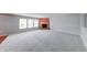 Living room with plush carpeting, a red accent wall, and a brick fireplace at 5989 Ashmore Ln, Carmel, IN 46033