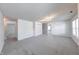 Vast living area with neutral carpeting, updated lighting, and plenty of natural light at 5989 Ashmore Ln, Carmel, IN 46033