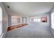 Spacious living room features soft gray walls, plush carpeting, a red accent wall, and hardwood flooring at 5989 Ashmore Ln, Carmel, IN 46033