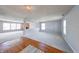 Living room featuring plush gray carpeting, soft gray walls, hardwood flooring, and an open wall cutout at 5989 Ashmore Ln, Carmel, IN 46033