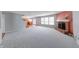 Open living room with hardwood floors, gray walls, a brick fireplace, and an eat-in kitchen at 5989 Ashmore Ln, Carmel, IN 46033