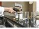 Close-up of drinks being poured into stylish glasses on a sleek, modern bar top, offering a luxurious entertaining space at 624 E Walnut St # 21, Indianapolis, IN 46204