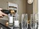 Wet bar with champagne glasses being poured at 624 E Walnut St # 21, Indianapolis, IN 46204
