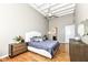 Bedroom with large window, ceiling fan, hardwood floors, and stylish decor at 624 E Walnut St # 21, Indianapolis, IN 46204