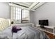 Bedroom with hardwood floors, large window, and television at 624 E Walnut St # 21, Indianapolis, IN 46204