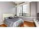 Bedroom with hardwood floors and a large window at 624 E Walnut St # 21, Indianapolis, IN 46204