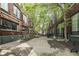 Red brick building exterior with a courtyard and mature trees at 624 E Walnut St # 21, Indianapolis, IN 46204