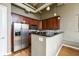 Kitchen features stainless steel appliances, granite counters, and wooden cabinets at 624 E Walnut St # 21, Indianapolis, IN 46204