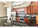 Kitchen features granite counters, stainless appliances, wooden cabinets, and breakfast bar at 624 E Walnut St # 21, Indianapolis, IN 46204