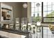 Wet bar with elegant stone countertop with tall windows adding natural light at 624 E Walnut St # 21, Indianapolis, IN 46204