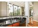 Stylish kitchen has stainless steel appliances, black granite countertop and exposed beam ceiling at 624 E Walnut St # 21, Indianapolis, IN 46204