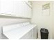 Laundry room with white washer and dryer, white cabinets, and sign at 624 E Walnut St # 21, Indianapolis, IN 46204