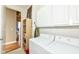 Laundry room with white washer and dryer, white cabinets, and shelving at 624 E Walnut St # 21, Indianapolis, IN 46204