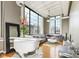 Spacious living room with large windows, hardwood floors, and a comfortable gray sofa at 624 E Walnut St # 21, Indianapolis, IN 46204