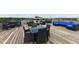 Relax on the rooftop deck, featuring wicker furniture and open sky views at 624 E Walnut St # 21, Indianapolis, IN 46204
