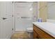 Bathroom featuring a vanity with wood cabinets and a glass-enclosed shower at 6404 Bayside Ct, Indianapolis, IN 46250