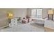 Cozy bedroom featuring a bed, chair, desk, and natural light from the window at 6404 Bayside Ct, Indianapolis, IN 46250
