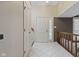Bright foyer with tiled floors, staircase, coat closet, and a view of the front door at 6404 Bayside Ct, Indianapolis, IN 46250