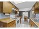 Well-lit kitchen features wooden cabinetry, white appliances, and tile flooring at 6404 Bayside Ct, Indianapolis, IN 46250
