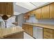Well-lit kitchen features wooden cabinetry, white appliances, and tile flooring at 6404 Bayside Ct, Indianapolis, IN 46250