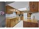 Well-lit kitchen features wooden cabinetry, white appliances, and tile flooring at 6404 Bayside Ct, Indianapolis, IN 46250