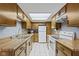 Well-lit kitchen features wooden cabinetry, white appliances, and tile flooring at 6404 Bayside Ct, Indianapolis, IN 46250