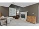 Cozy living room features a stone fireplace, neutral carpet, and ample natural light at 6404 Bayside Ct, Indianapolis, IN 46250