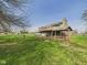 Beautiful backyard view showcasing the home's deck and covered patio area, ideal for outdoor living at 6413 N Wheeling Ave, Muncie, IN 47304