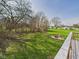 Expansive green backyard featuring a fire pit and chairs, perfect for outdoor gatherings and relaxation at 6413 N Wheeling Ave, Muncie, IN 47304