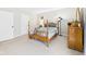 Bedroom featuring a four-poster bed and carpet flooring at 6413 N Wheeling Ave, Muncie, IN 47304