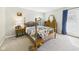 Cozy bedroom with a four-poster bed, wooden furniture, and soft natural light at 6413 N Wheeling Ave, Muncie, IN 47304