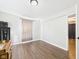 Bright bedroom with hardwood floors, a closet, and large windows, offering ample natural light at 6413 N Wheeling Ave, Muncie, IN 47304