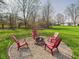 Backyard fire pit area with chairs at 6413 N Wheeling Ave, Muncie, IN 47304
