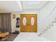 Open foyer with stone floors, double doors, and a staircase leading to the upper level at 6413 N Wheeling Ave, Muncie, IN 47304