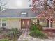 Stunning stone facade with beautiful wood double doors and a well-manicured front garden at 6413 N Wheeling Ave, Muncie, IN 47304