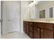 Bathroom featuring a double vanity, large mirror and door to shower at 6524 Turf Way, Anderson, IN 46013