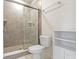 Bathroom featuring glass enclosed shower, toilet and storage at 6524 Turf Way, Anderson, IN 46013