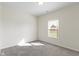 Bright bedroom featuring neutral walls, large window providing natural light, and plush carpet at 6524 Turf Way, Anderson, IN 46013