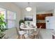 Bright dining area features a round table, stylish chairs, and a view of the kitchen at 6524 Turf Way, Anderson, IN 46013