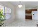 Open dining area with tile floor and window next to modern kitchen at 6524 Turf Way, Anderson, IN 46013