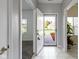 Bright and airy foyer with white tile flooring, fresh paint, and a view of the front yard at 6524 Turf Way, Anderson, IN 46013