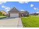 Charming brick home features a well-maintained lawn and attached two-car garage at 6524 Turf Way, Anderson, IN 46013
