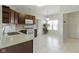 Open-concept kitchen featuring brown cabinets, white appliances, and marble tile flooring at 6524 Turf Way, Anderson, IN 46013