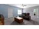 Comfortable living room with a ceiling fan and neutral carpeting at 6524 Turf Way, Anderson, IN 46013