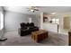 Open living room with comfortable leather seating and neutral carpeting at 6524 Turf Way, Anderson, IN 46013